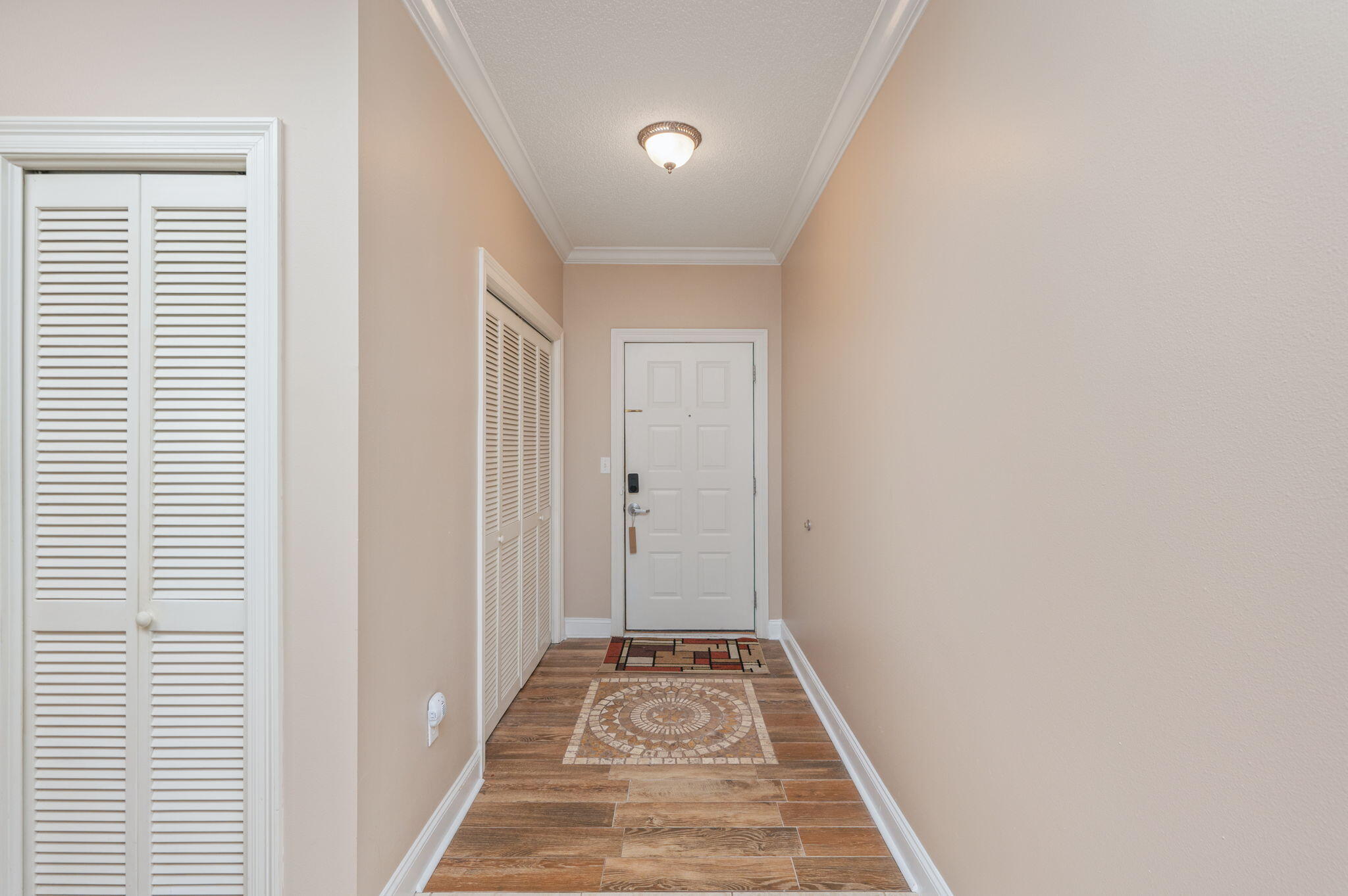 5 Laguna Street, Unit 104 Fort Walton Beach, FL 32548 - Photo 39 of 40 a view of a room with wooden floor and windows