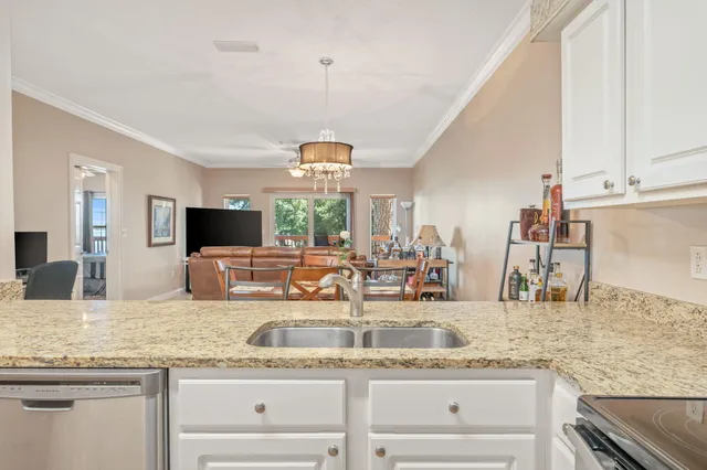 a kitchen with granite countertop a sink and a stainless steel appliances