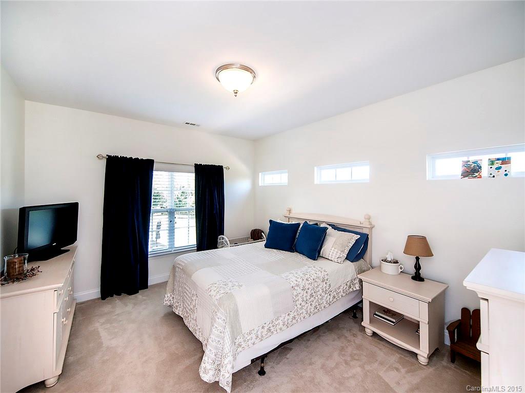 735 Quicksilver Trail Fort Mill, SC 29708 - Photo 12 of 20 a bedroom with a bed and a flat screen tv