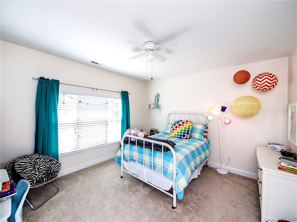 735 Quicksilver Trail Fort Mill, SC 29708 - Photo 13 of 20 a bedroom with a bed and a chair