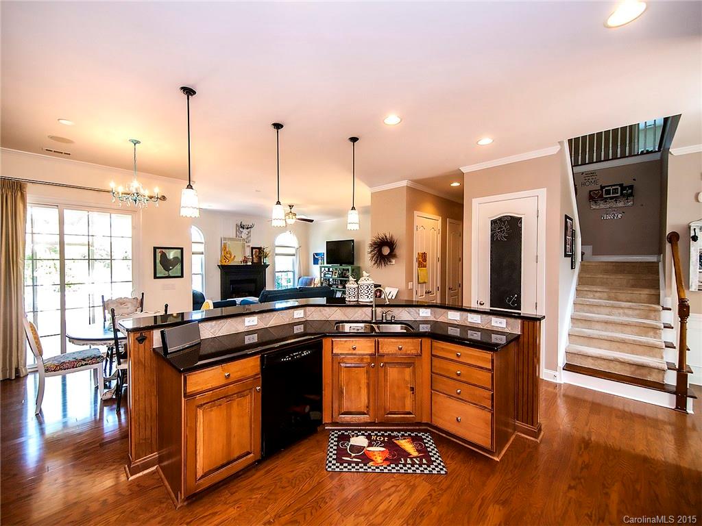 735 Quicksilver Trail Fort Mill, SC 29708 - Photo 6 of 20 a kitchen with stainless steel appliances granite countertop a stove a sink and a wooden floors