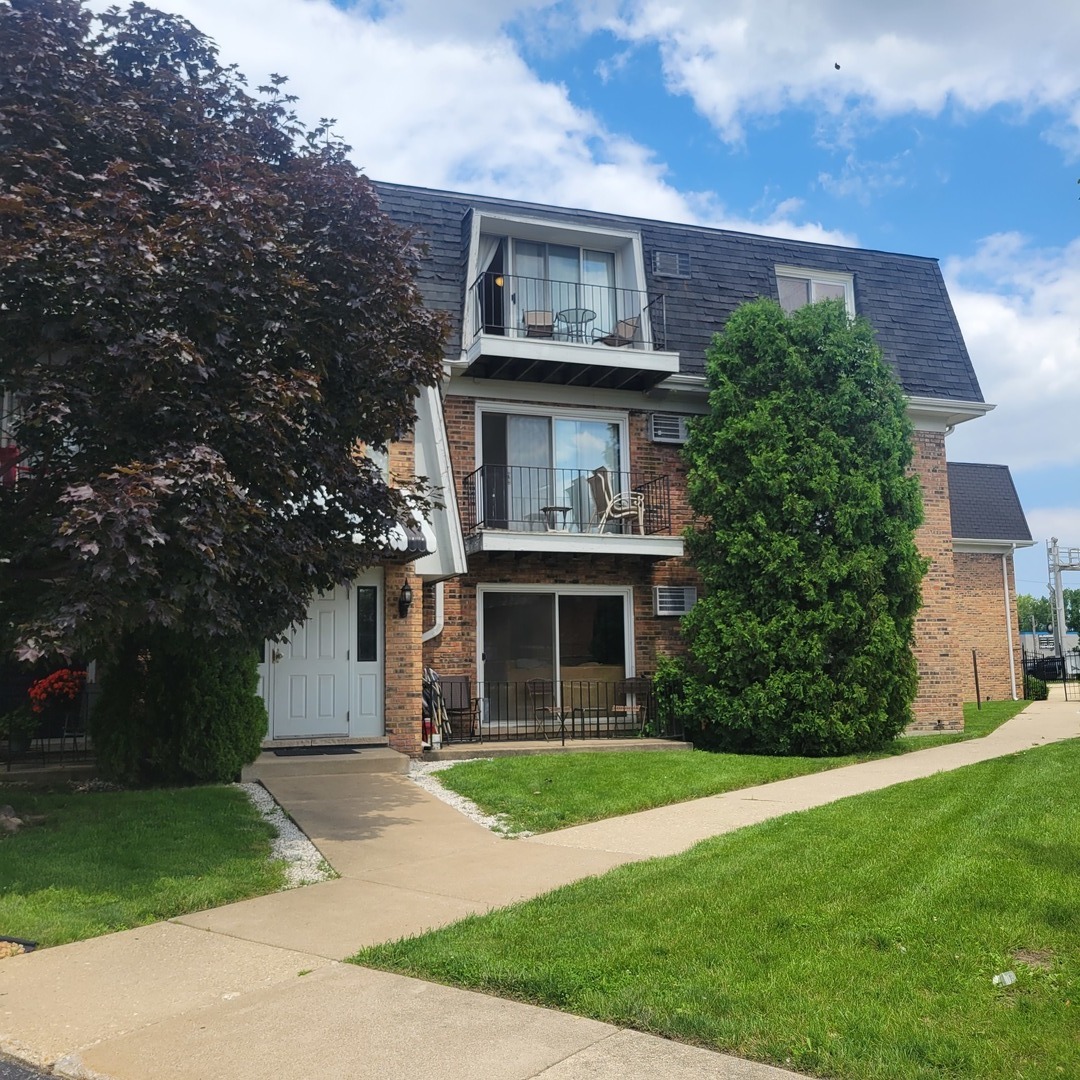 10330 Ridgeland Avenue, Unit 308 Chicago Ridge, IL 60415 - Photo 1 of 9 a view of house with a yard