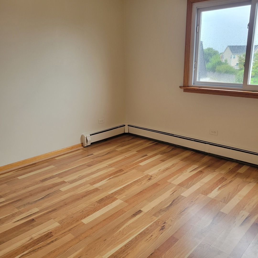 10330 Ridgeland Avenue, Unit 308 Chicago Ridge, IL 60415 - Photo 7 of 9 a view of a room with wooden floor and window