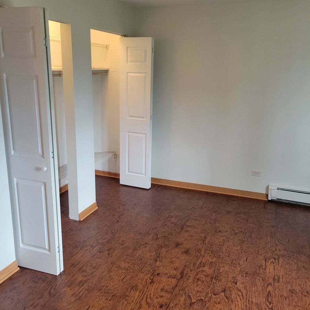 10330 Ridgeland Avenue, Unit 308 Chicago Ridge, IL 60415 - Photo 8 of 9 an empty room with a door