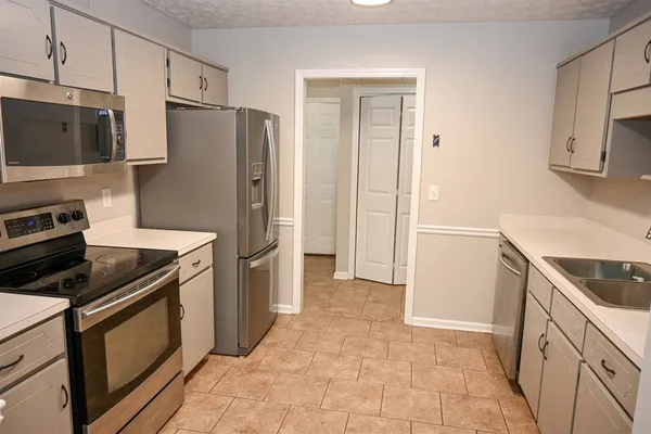 a kitchen with sink cabinets and microwave