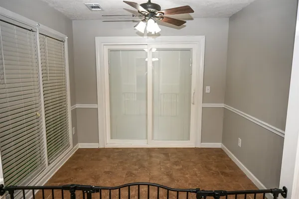a view of a hallway and a livingroom with furniture