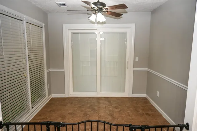 a view of a hallway and a livingroom with furniture