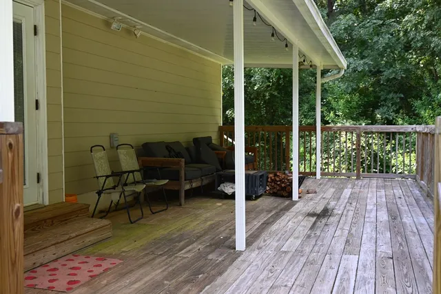 a view of balcony with furniture and wooden floor