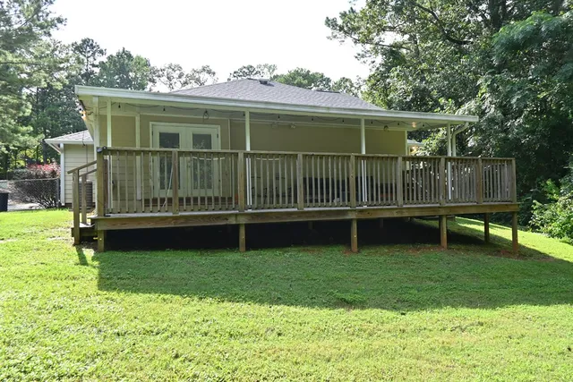 a view of a chair and table in backyard of the house