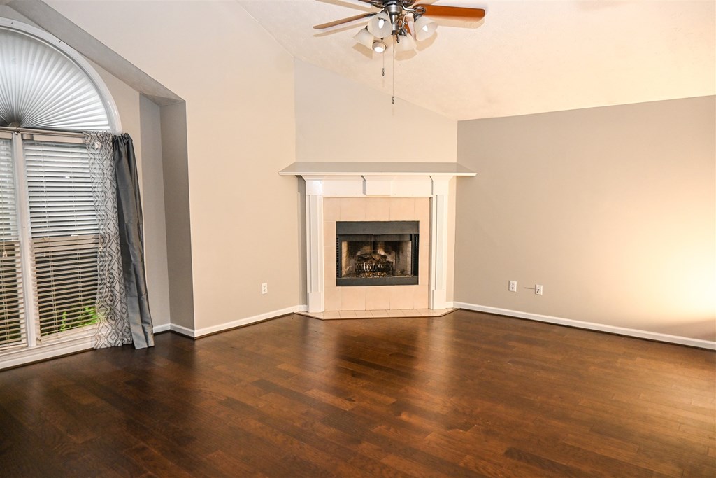 332 West Pine Drive Fortson, GA 31808 - Photo 8 of 26 an empty room with wooden floor fireplace and windows