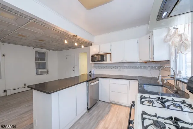 a kitchen with a sink cabinets and window