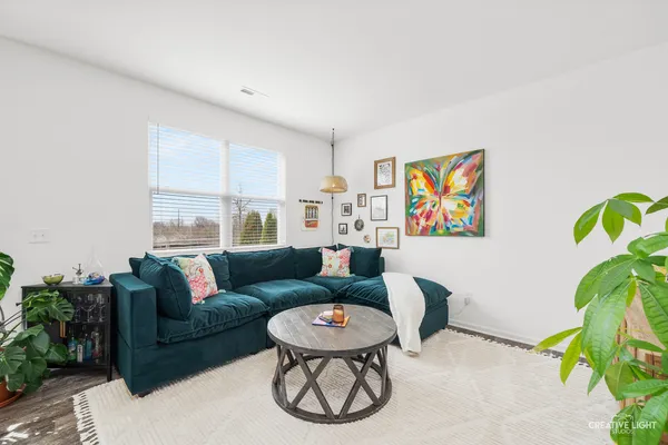 a living room with furniture a rug and a window