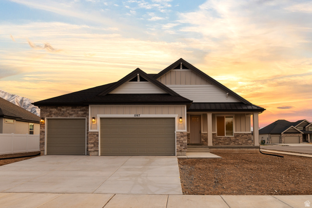 1567 West 600 North, Unit MARSHA Springville, UT 84663 - Photo 1 of 1 Craftsman house featuring board and batten siding, a porch, an attached garage, driveway, and stone siding