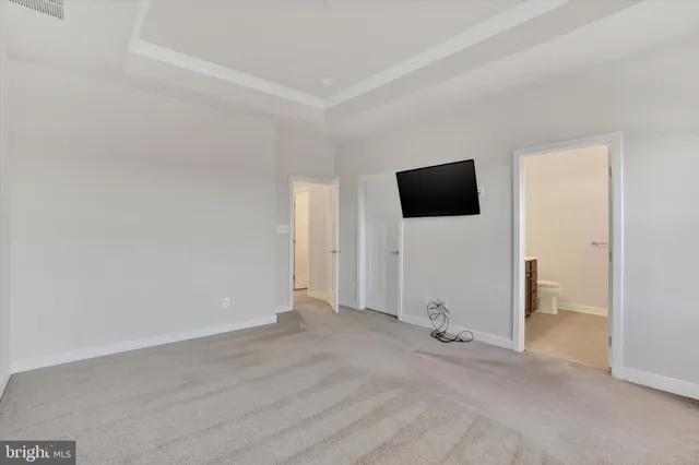 a view of a livingroom with wooden floor and a flat screen tv