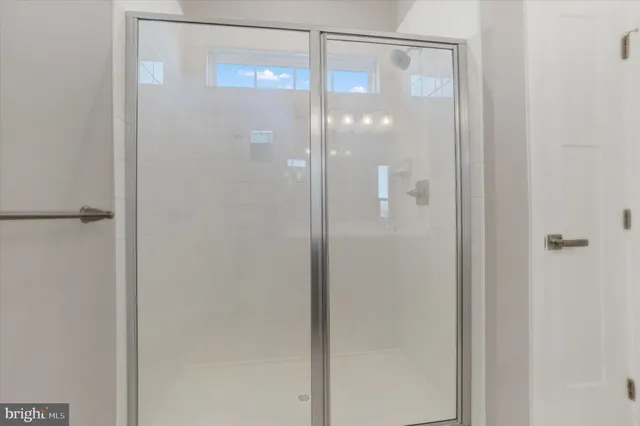 a bathroom with a glass shower door