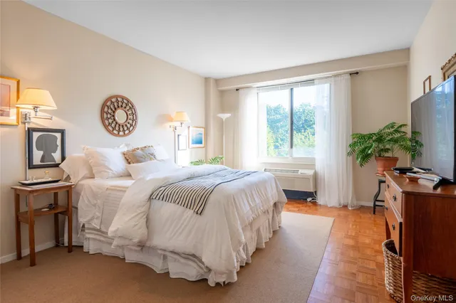 a bedroom with bed and flowerpot