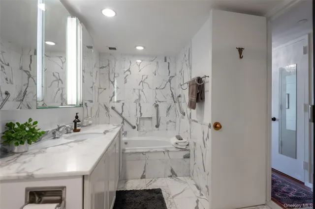 a bathroom with a granite countertop sink a toilet and shower
