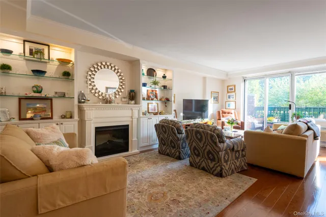 a living room with furniture large window and a fireplace