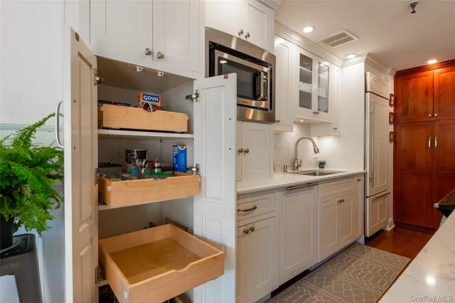 a dining room with furniture potted plants and wooden floor