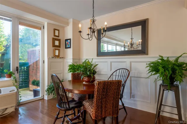 a view of a dining room with furniture and chandelier