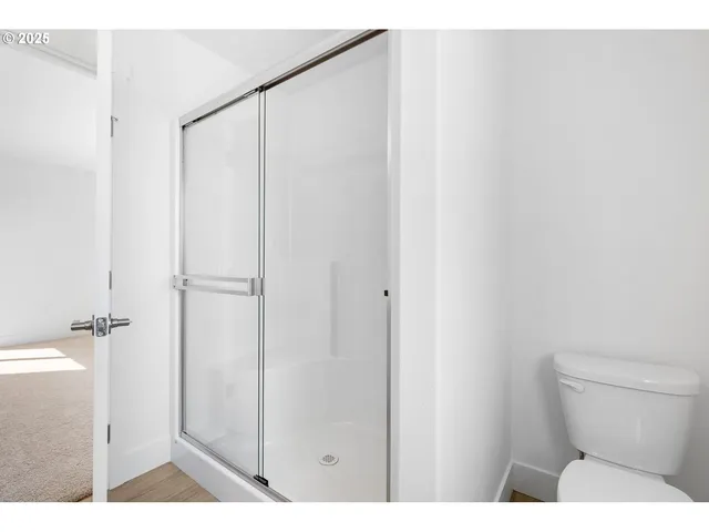 a bathroom with a shower a toilet and a sink