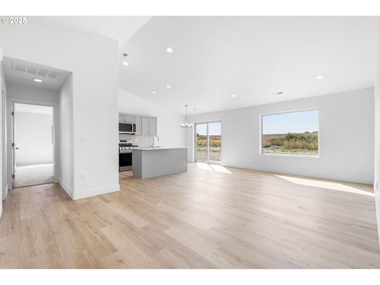 117 Tiber Street Boardman, OR 97818 - Photo 14 of 26 a view of an empty room with wooden floor and a window