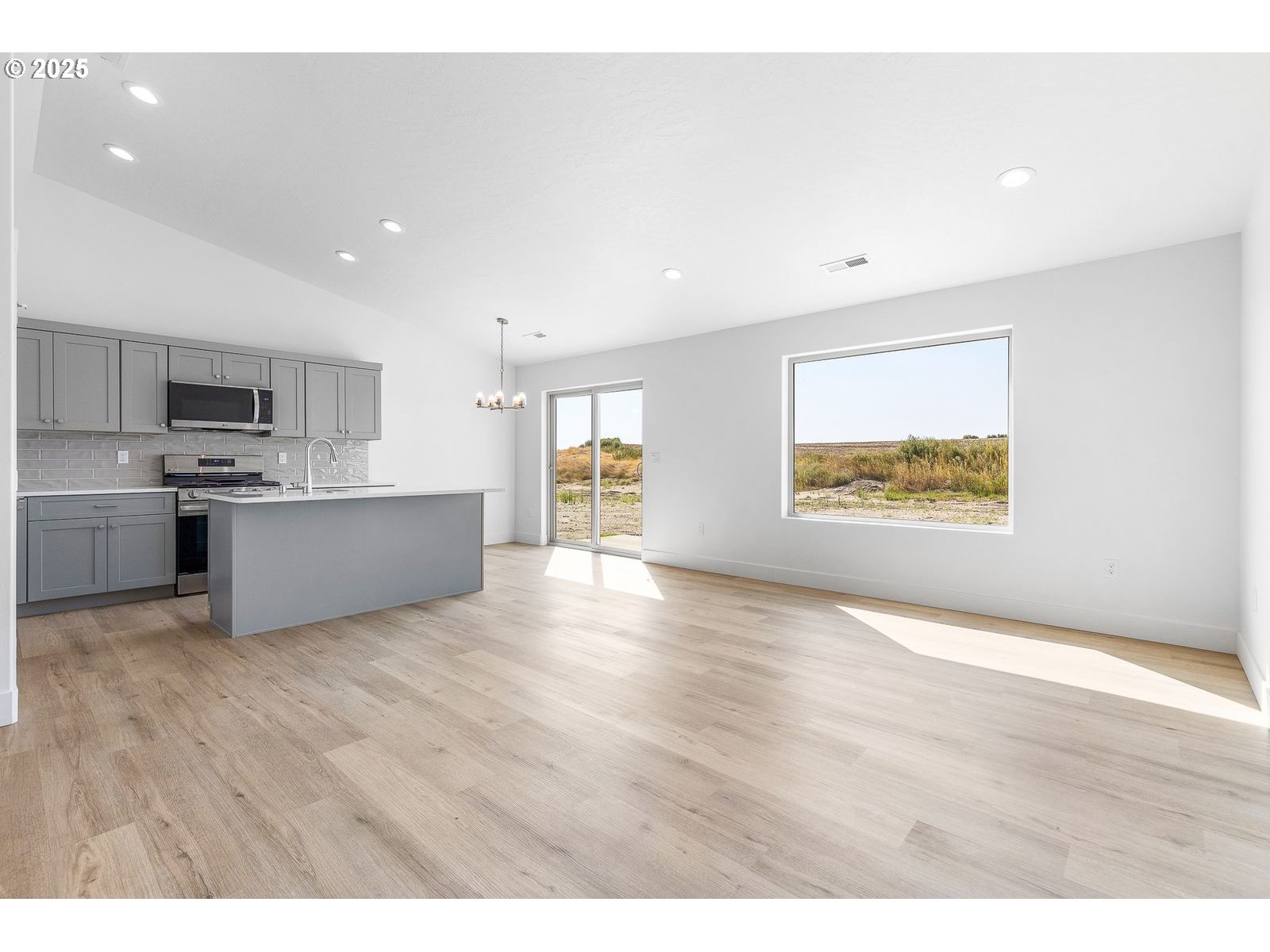 117 Tiber Street Boardman, OR 97818 - Photo 15 of 26 a view of an empty room with window and wooden floor