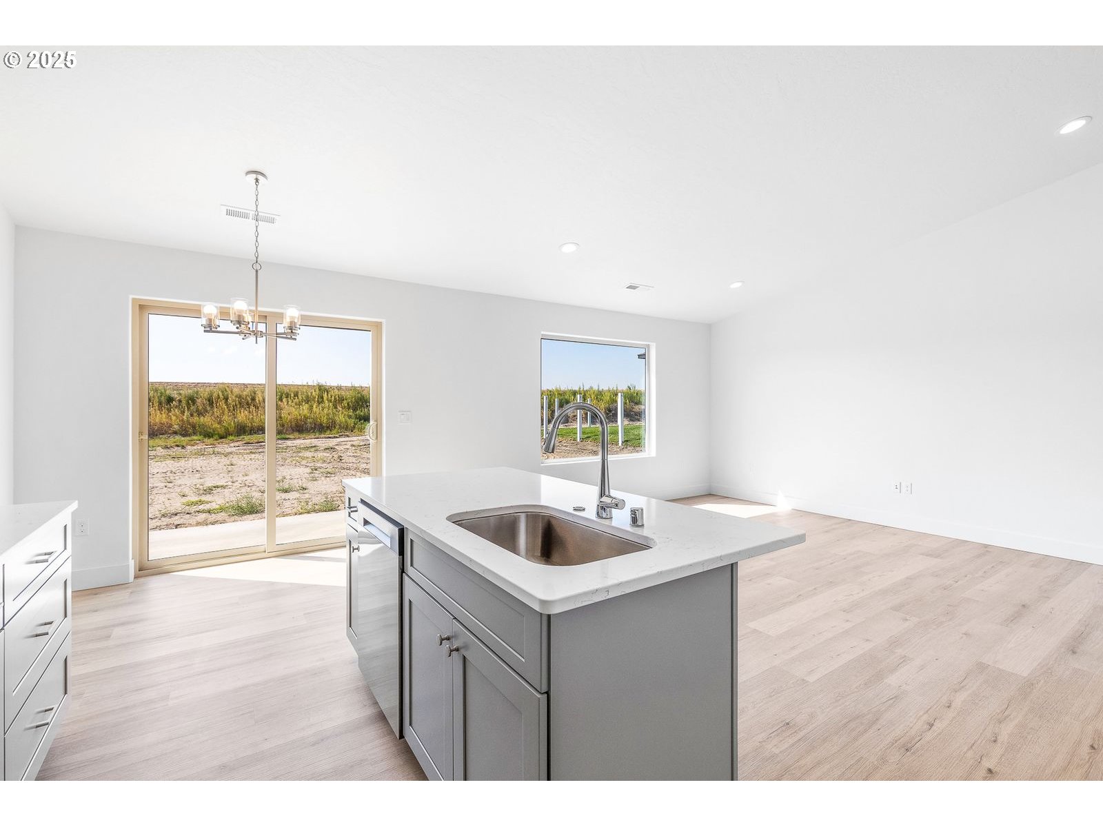 117 Tiber Street Boardman, OR 97818 - Photo 18 of 26 a kitchen with a sink and wooden floor