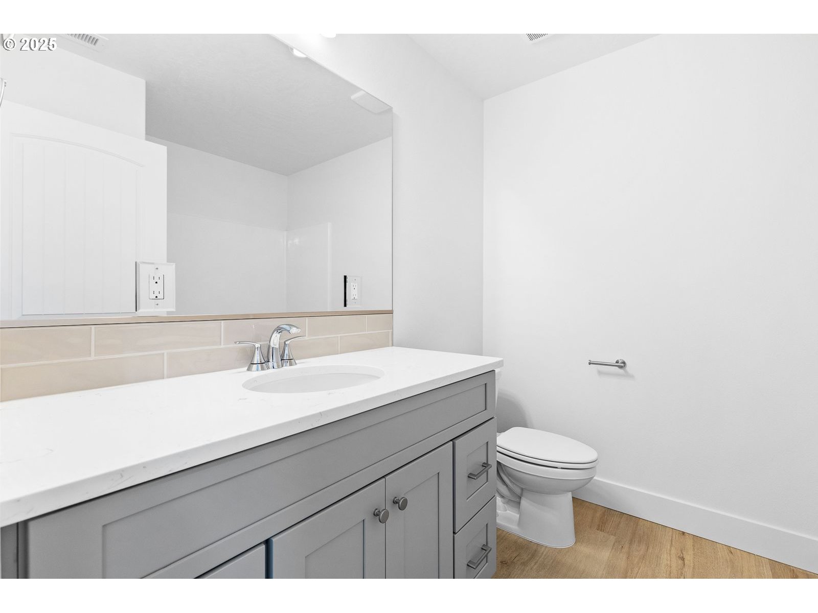 117 Tiber Street Boardman, OR 97818 - Photo 5 of 26 a bathroom with a granite countertop sink a toilet and a mirror