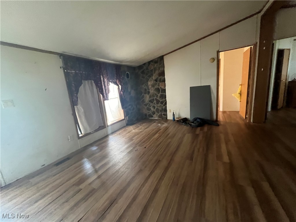 76303 Science Hill Road Kimbolton, OH 43749 - Photo 10 of 18 Unfurnished living room featuring vaulted ceiling and wood-type flooring