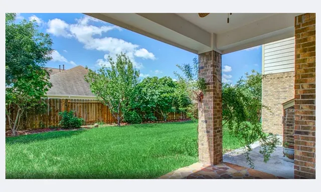 a view of yard with front door and porch