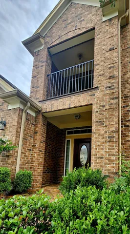 a front view of a house with plants