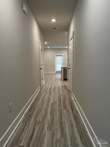 a view of a room with wooden floor