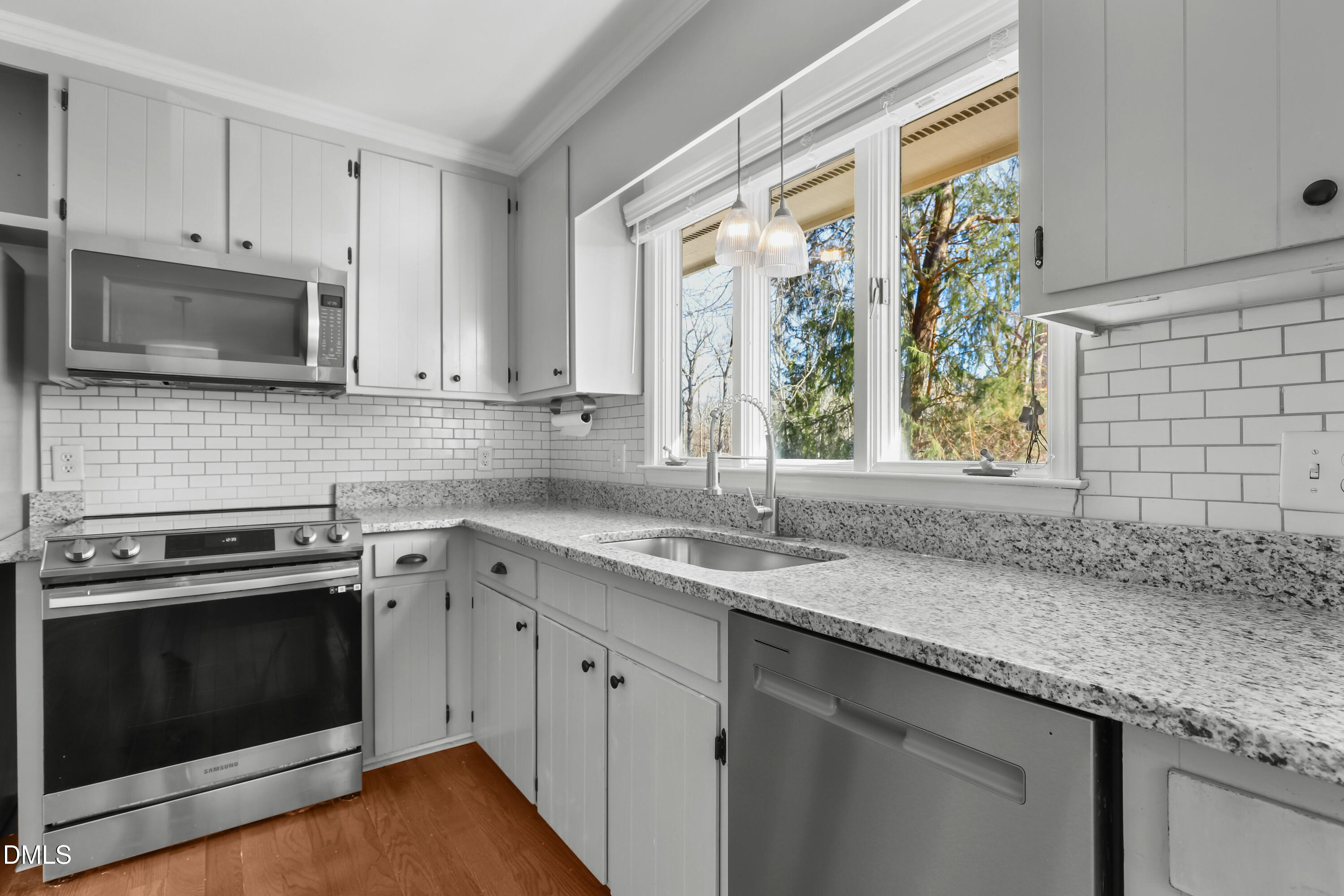 3504 Fairhill Drive Raleigh, NC 27612 - Photo 11 of 45 a kitchen with granite countertop stainless steel appliances a stove sink and microwave