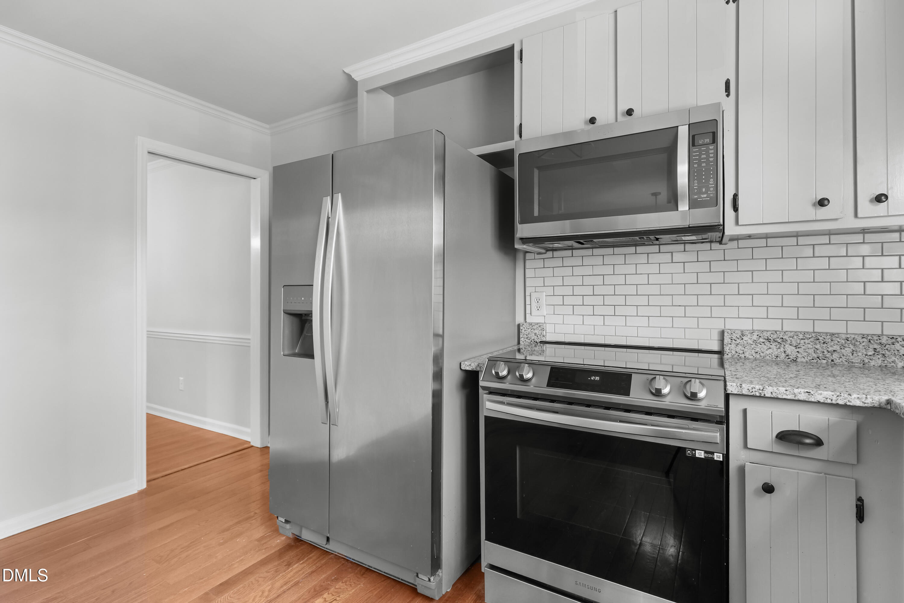 3504 Fairhill Drive Raleigh, NC 27612 - Photo 12 of 45 a kitchen with stainless steel appliances wooden cabinets and a wooden floor