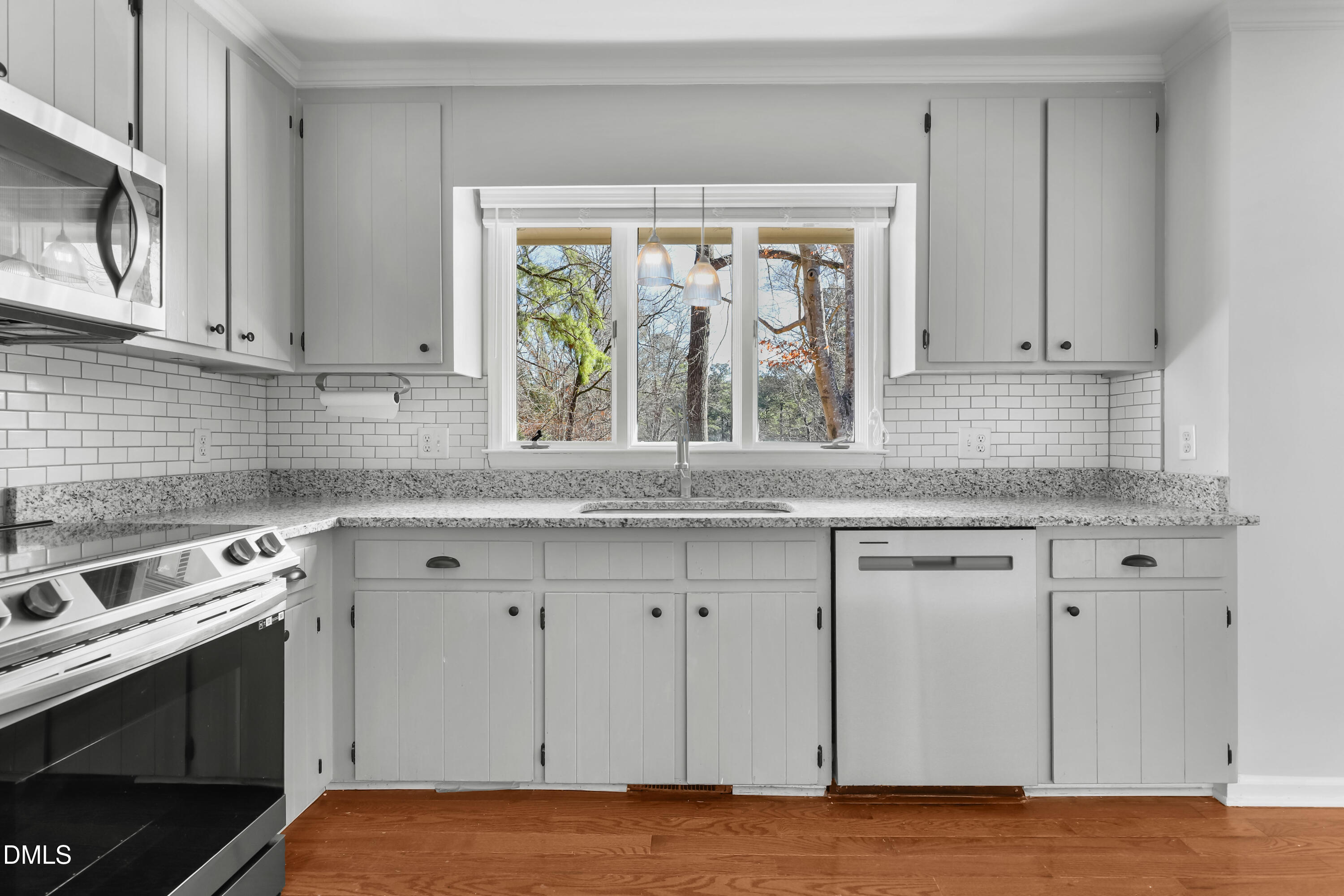 3504 Fairhill Drive Raleigh, NC 27612 - Photo 13 of 45 a kitchen with granite countertop white cabinets and a window