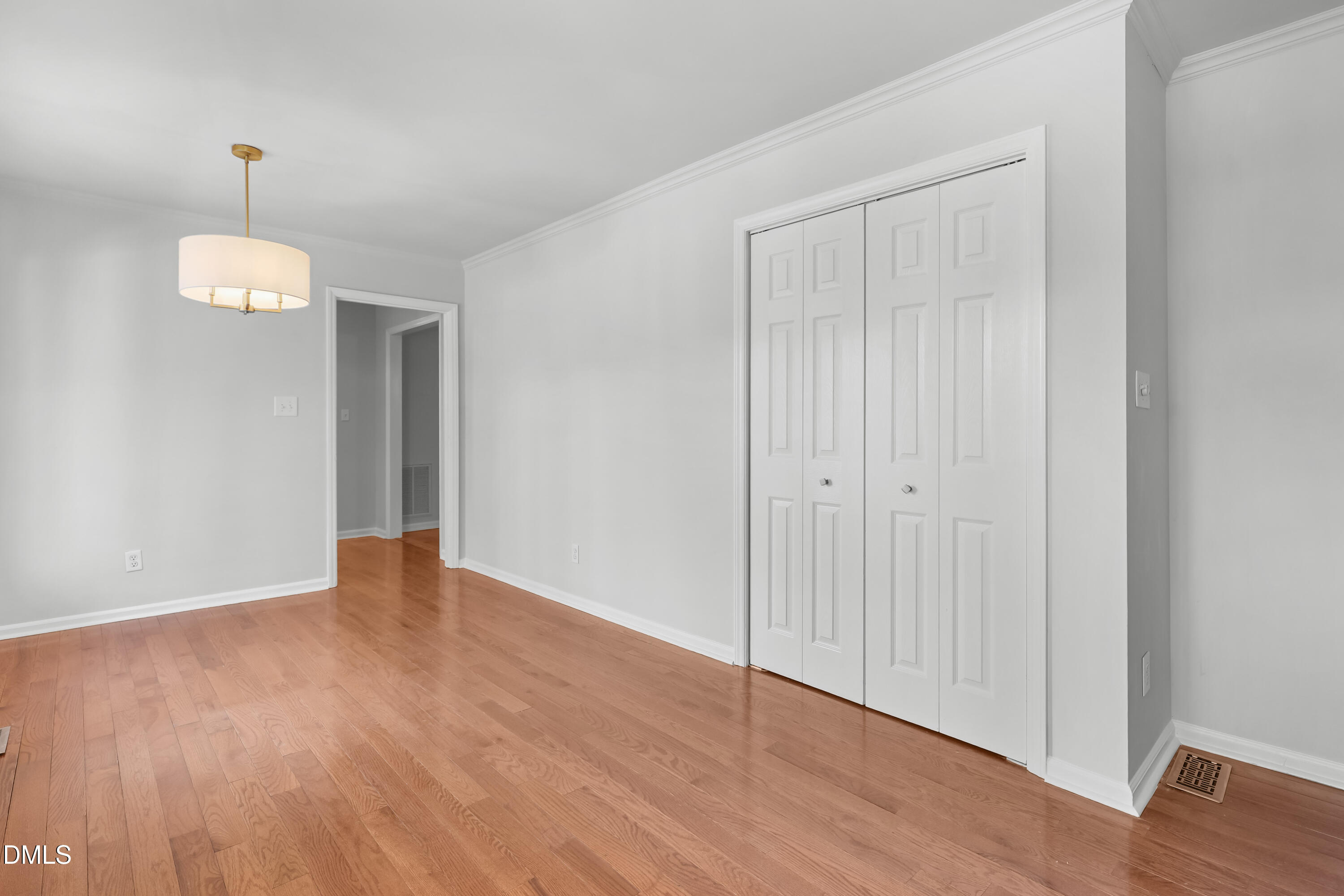 3504 Fairhill Drive Raleigh, NC 27612 - Photo 15 of 45 a view of an empty room with wooden floor