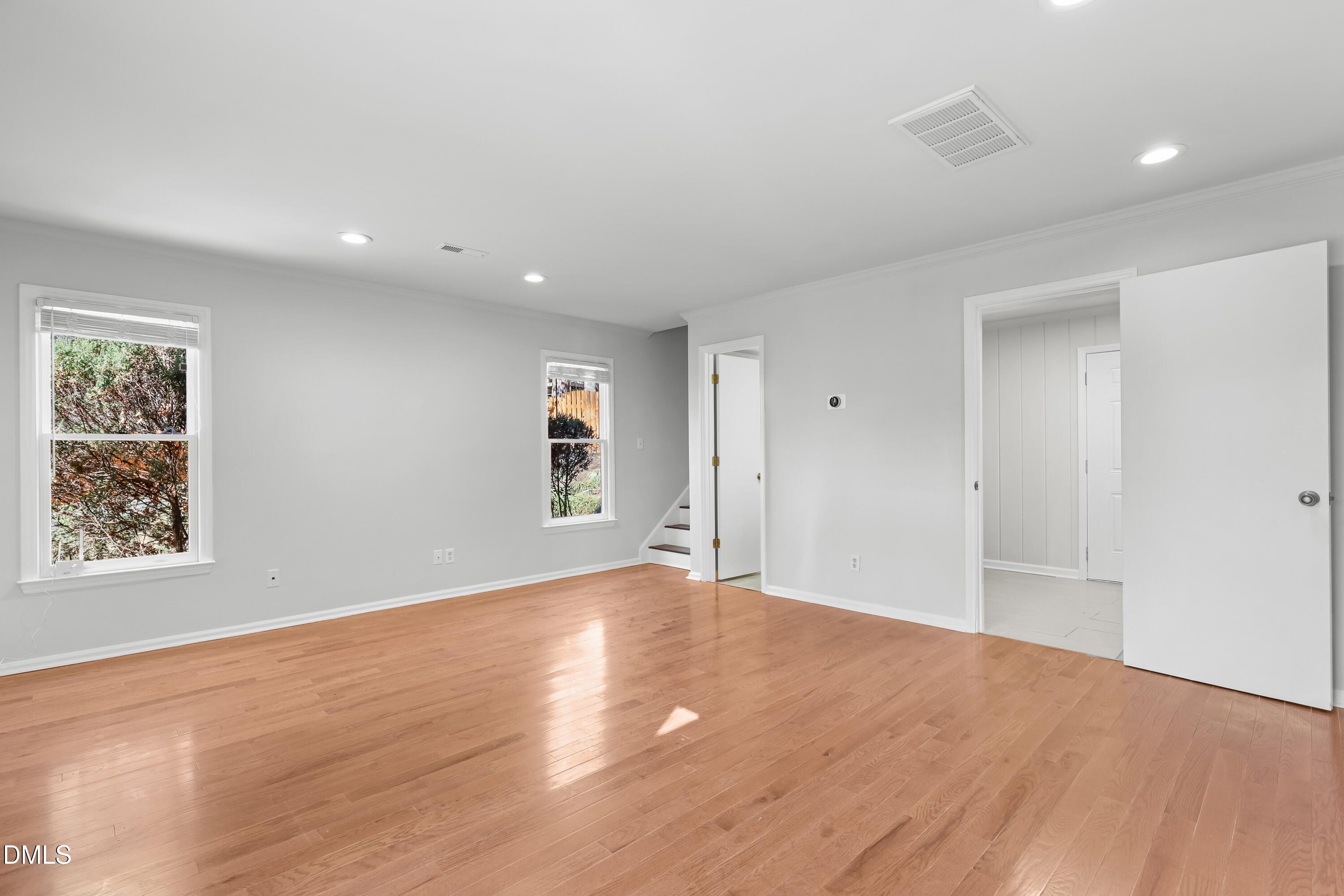 3504 Fairhill Drive Raleigh, NC 27612 - Photo 17 of 45 a view of an empty room with wooden floor and a window