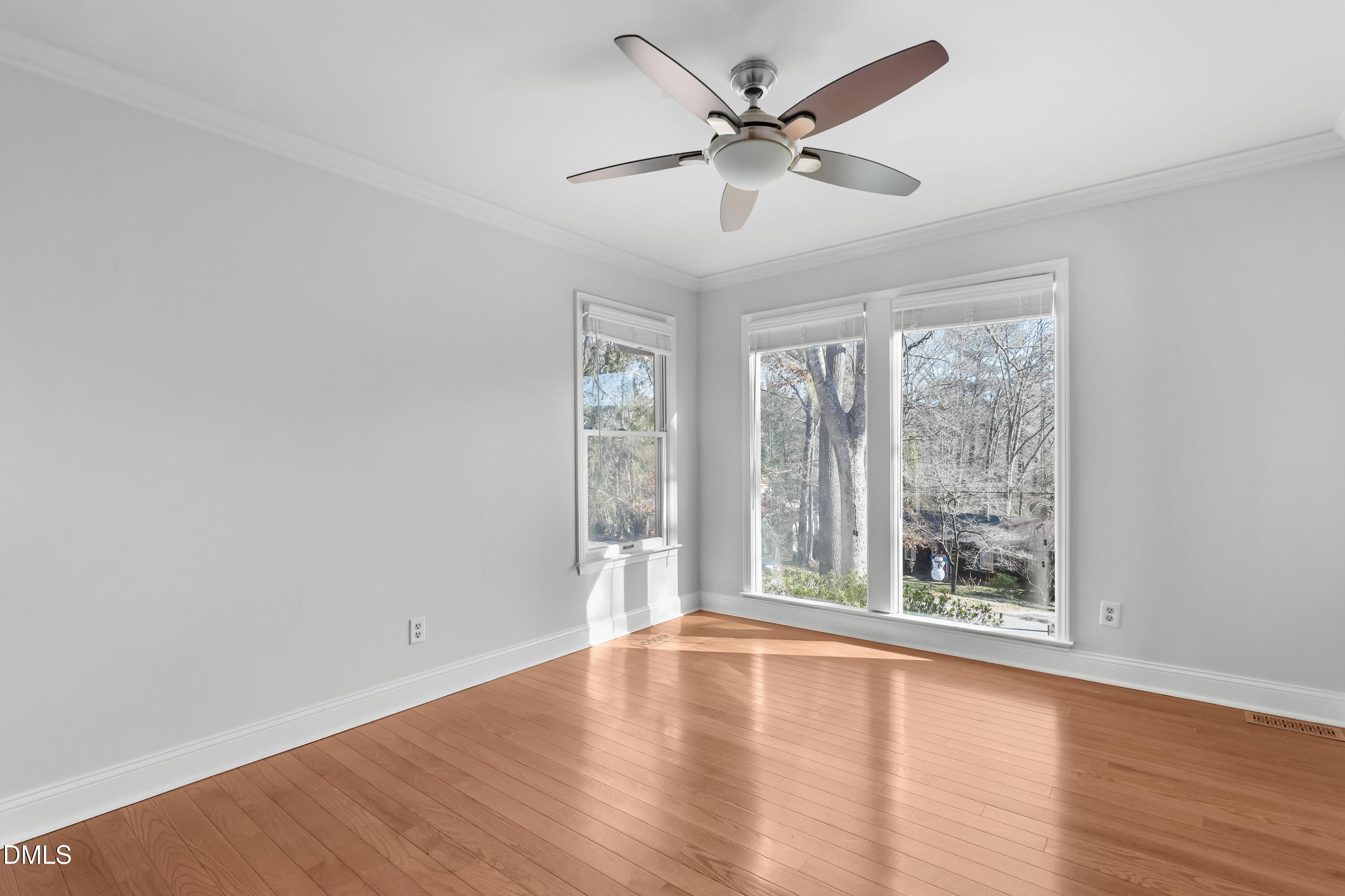 3504 Fairhill Drive Raleigh, NC 27612 - Photo 21 of 45 an empty room with wooden floor fan and windows