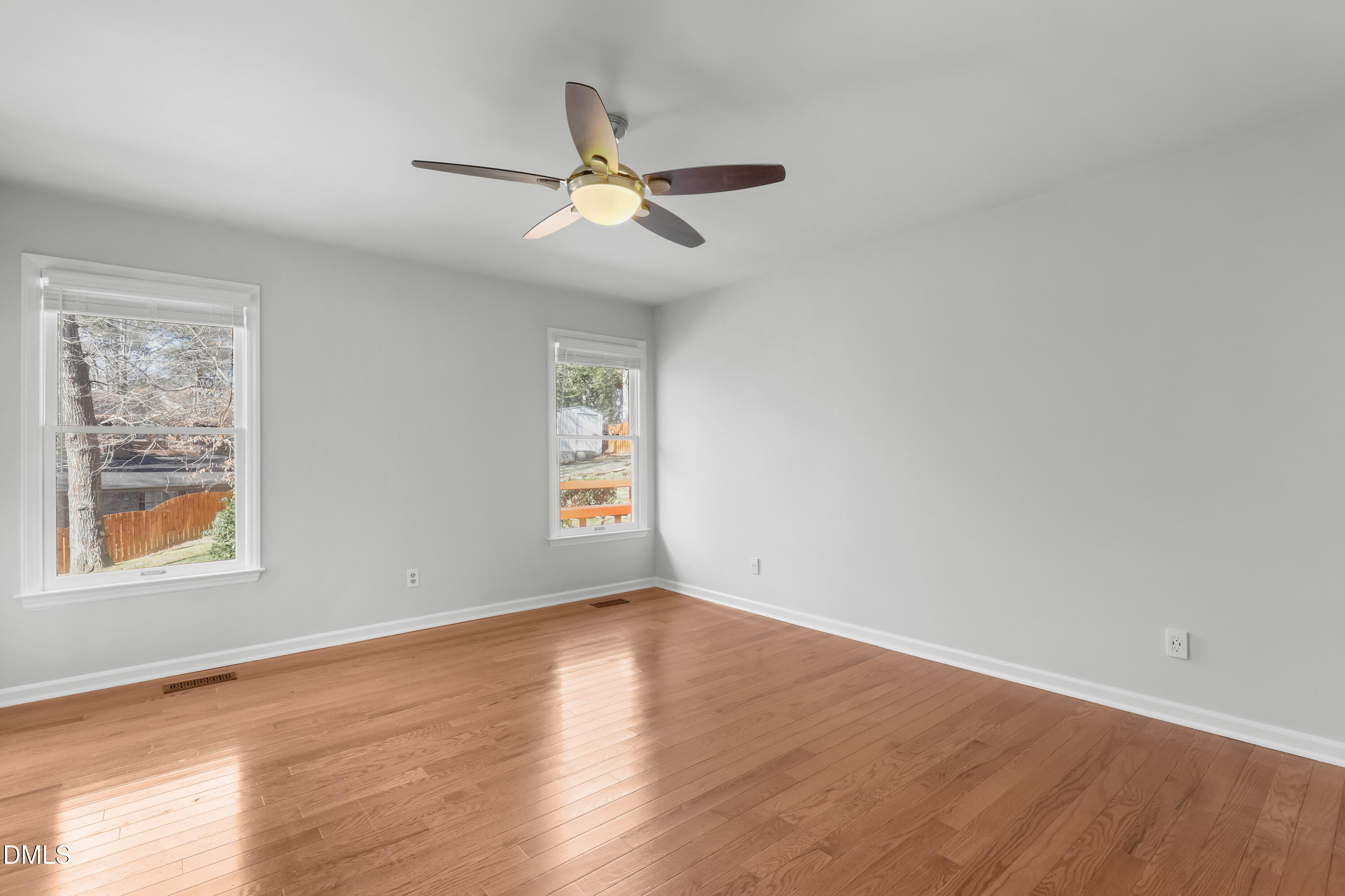 3504 Fairhill Drive Raleigh, NC 27612 - Photo 26 of 45 a view of an empty room with wooden floor and a window