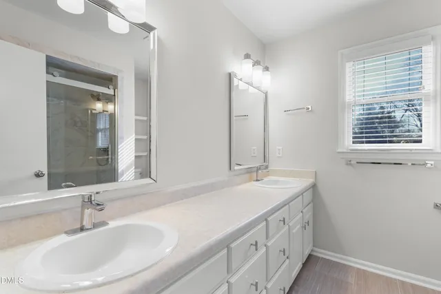 a bathroom with 2 sink and a mirror