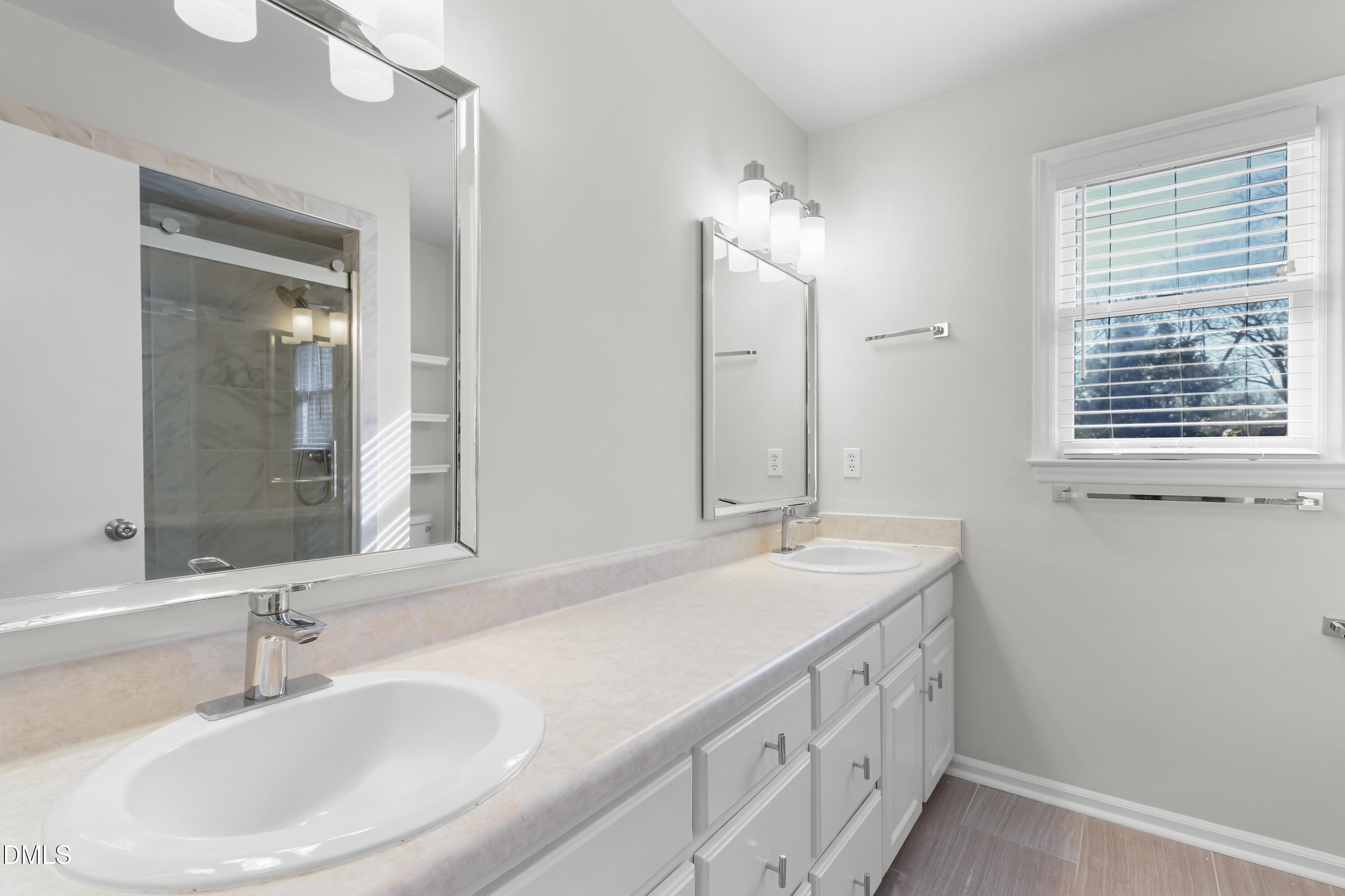3504 Fairhill Drive Raleigh, NC 27612 - Photo 28 of 45 a bathroom with 2 sink and a mirror