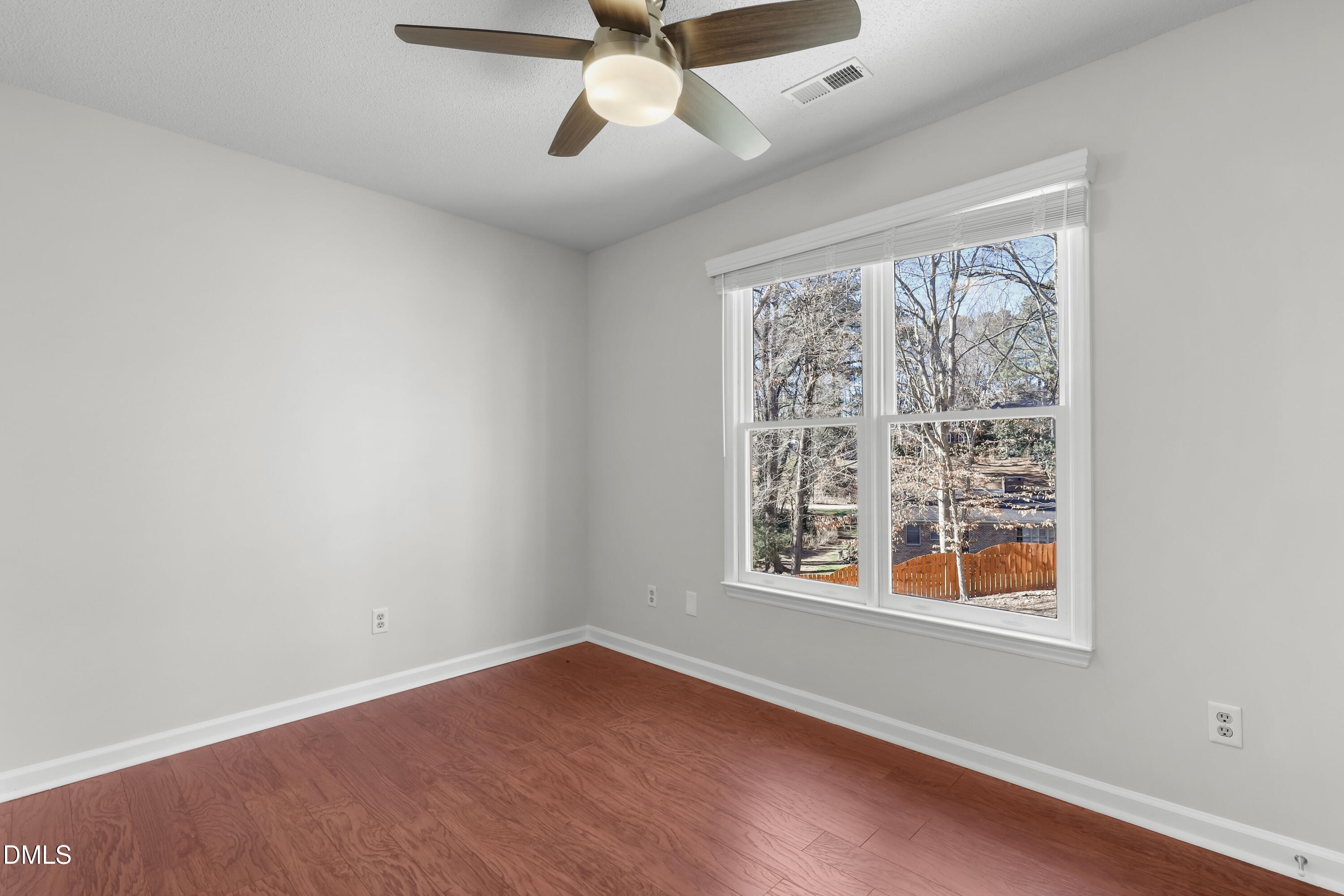3504 Fairhill Drive Raleigh, NC 27612 - Photo 34 of 45 a view of an empty room with wooden floor and a window