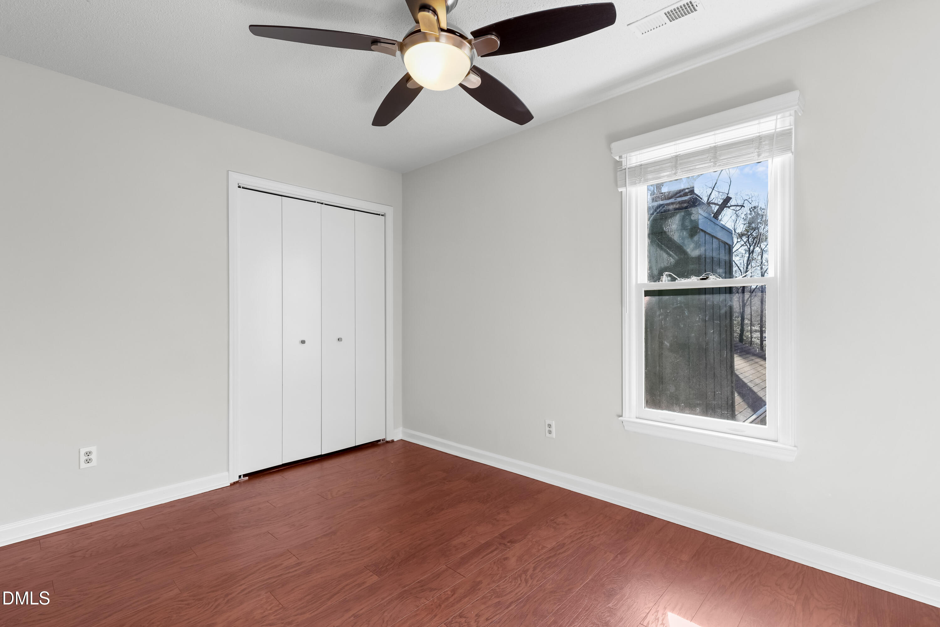3504 Fairhill Drive Raleigh, NC 27612 - Photo 36 of 45 an empty room with a window and a ceiling fan