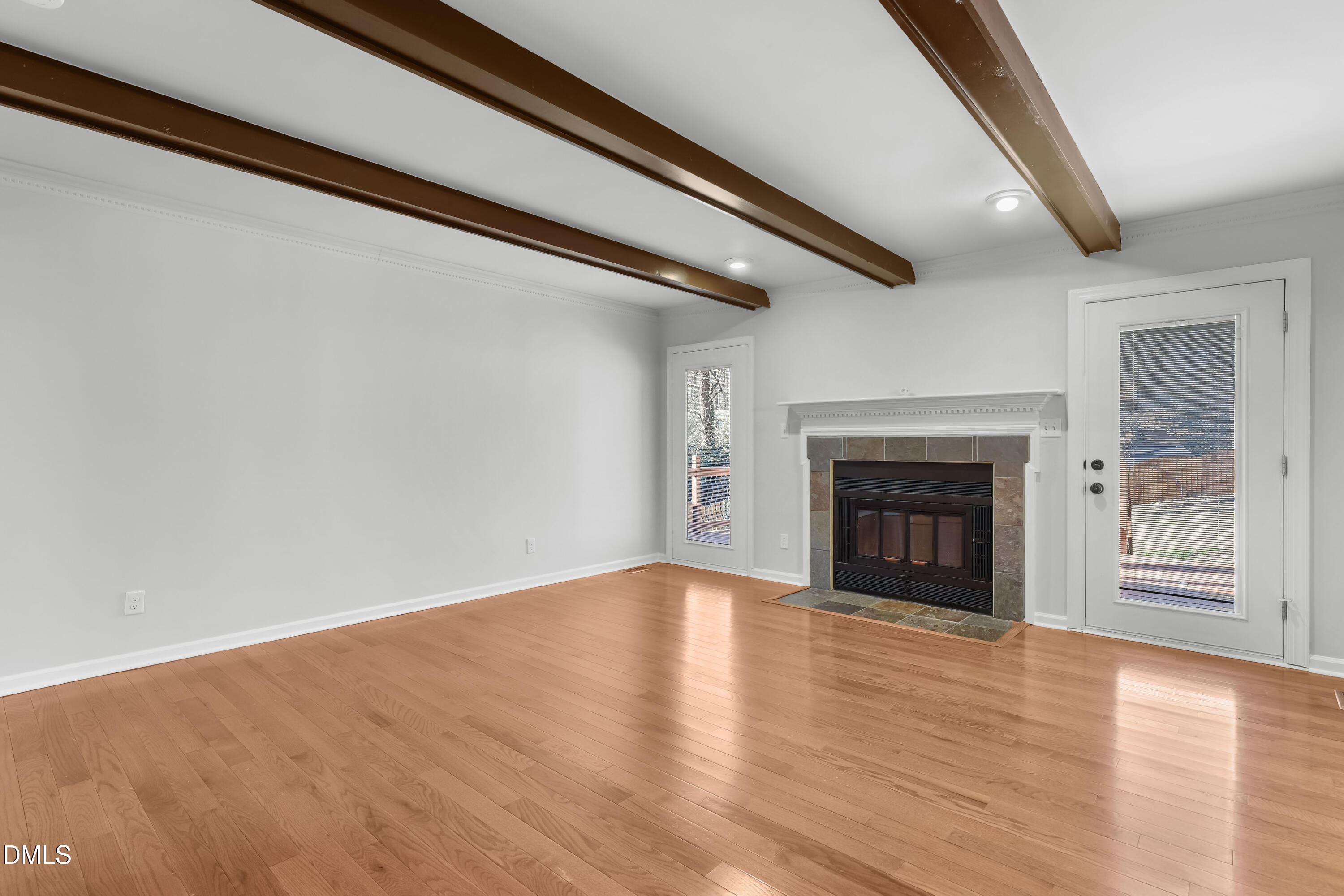 3504 Fairhill Drive Raleigh, NC 27612 - Photo 4 of 45 a view of empty room with wooden floor and fireplace