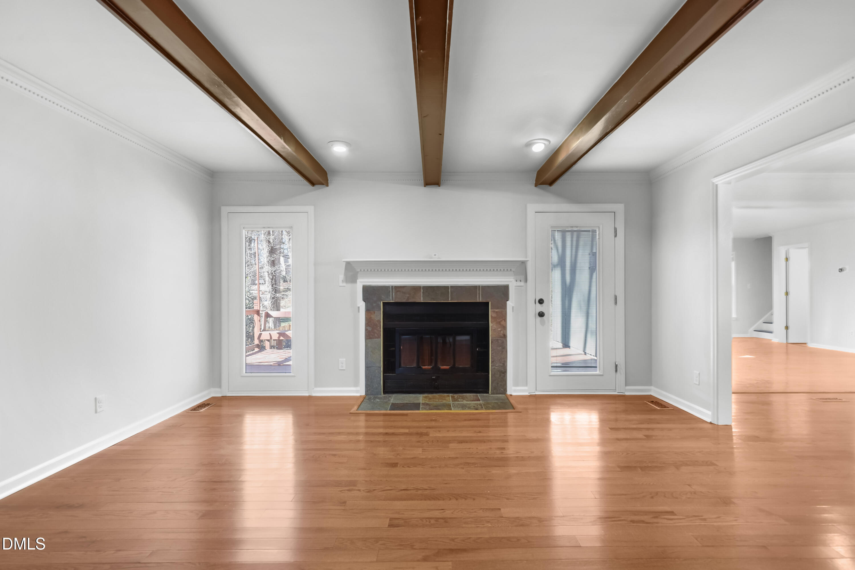 3504 Fairhill Drive Raleigh, NC 27612 - Photo 5 of 45 a view of a livingroom with wooden floor and a fireplace