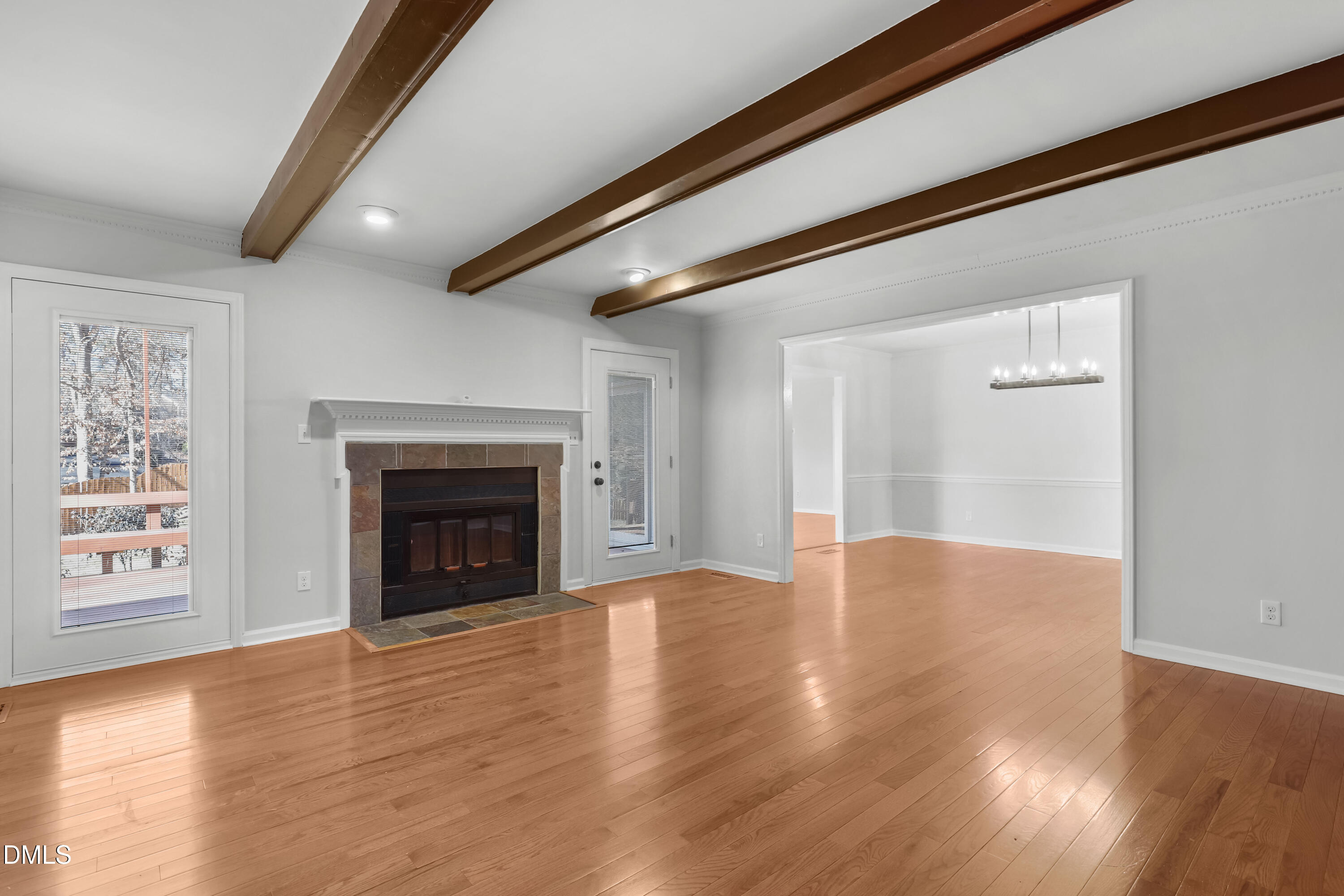 3504 Fairhill Drive Raleigh, NC 27612 - Photo 6 of 45 a view of an empty room with a fireplace and a window