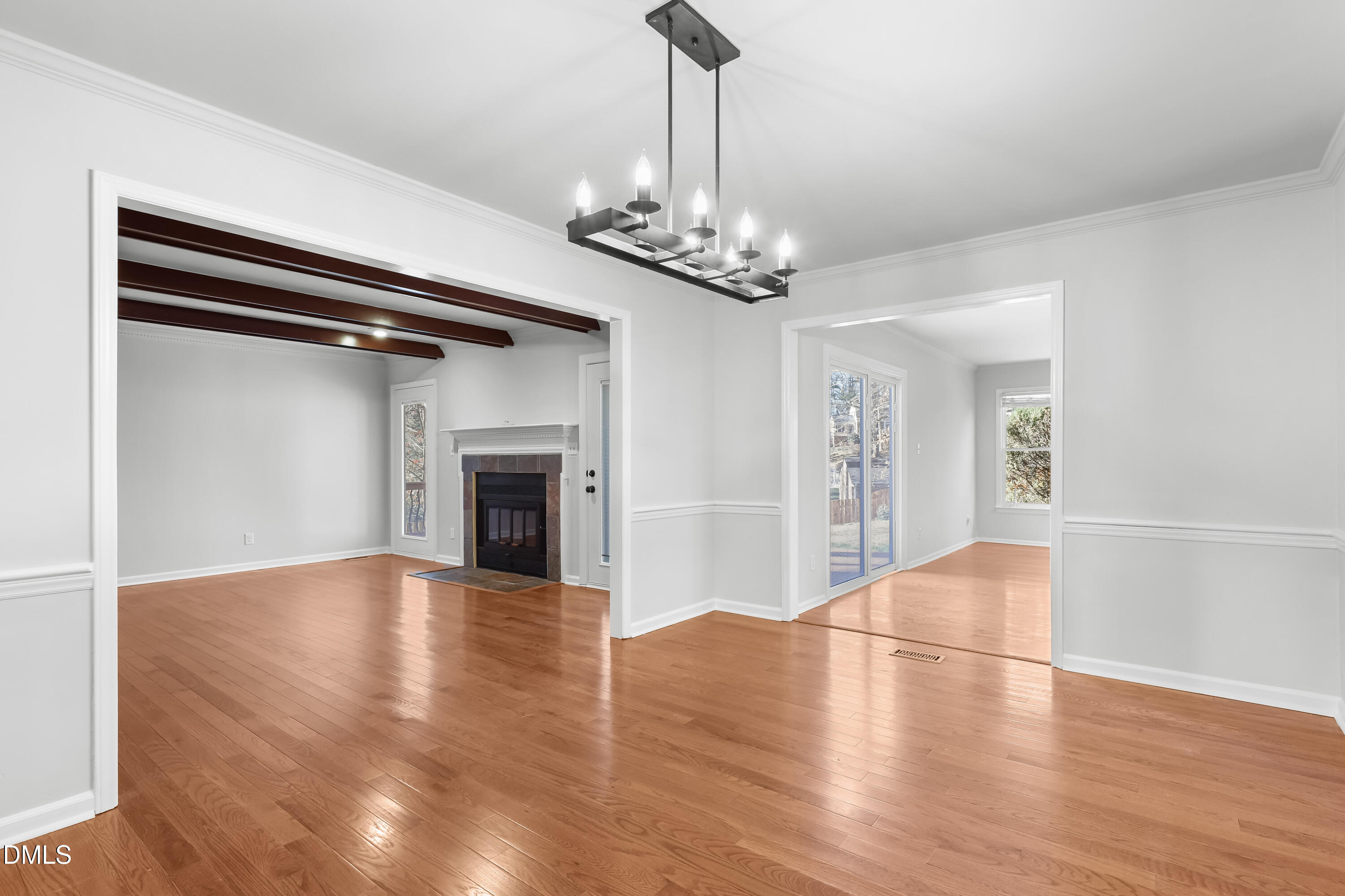 3504 Fairhill Drive Raleigh, NC 27612 - Photo 7 of 45 a view of a livingroom with wooden floor a fireplace and window
