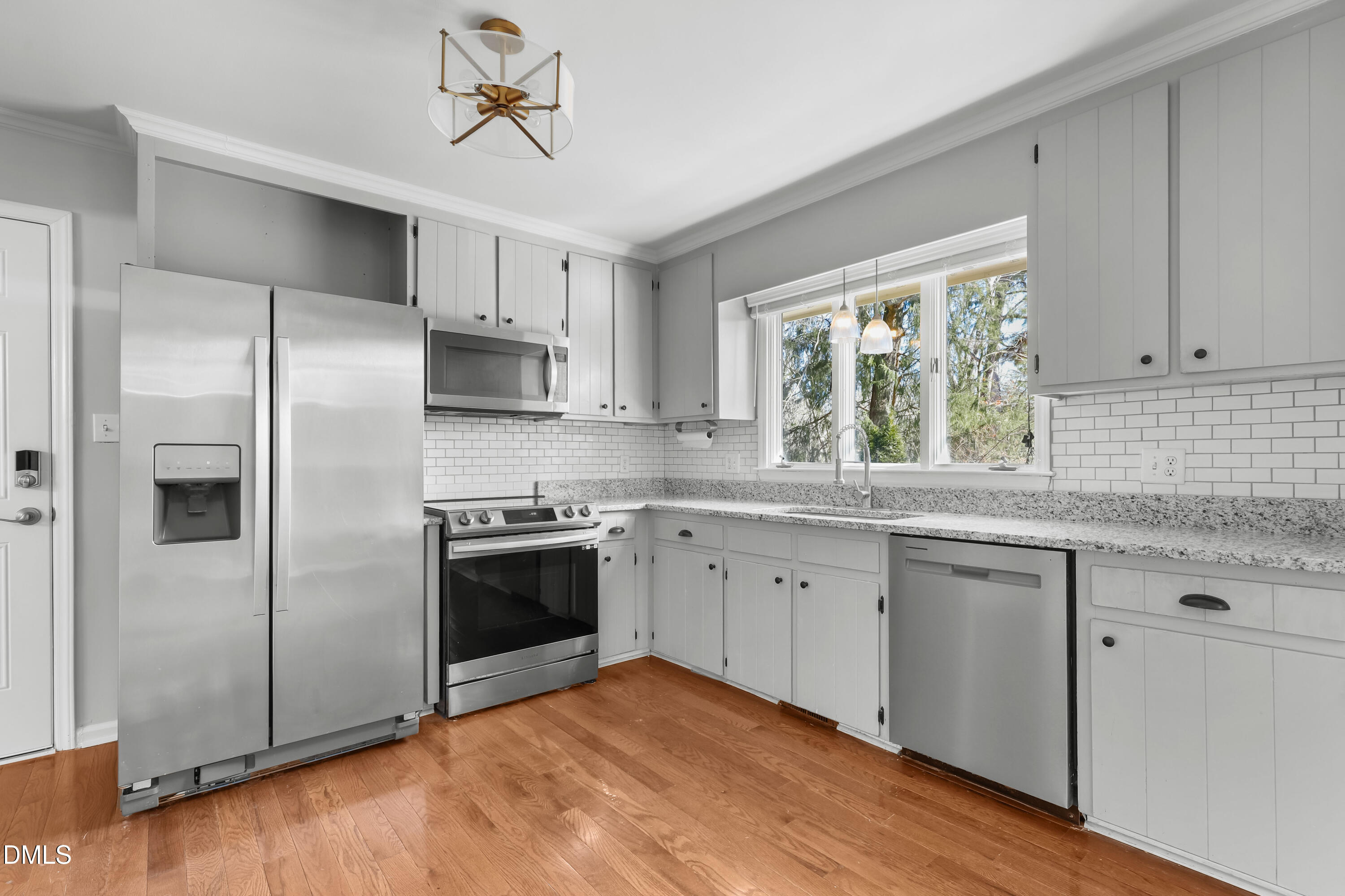 3504 Fairhill Drive Raleigh, NC 27612 - Photo 10 of 45 a kitchen with stainless steel appliances granite countertop a stove a refrigerator and a sink