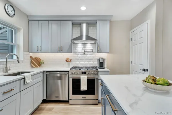 a kitchen with stainless steel appliances granite countertop a stove and a sink